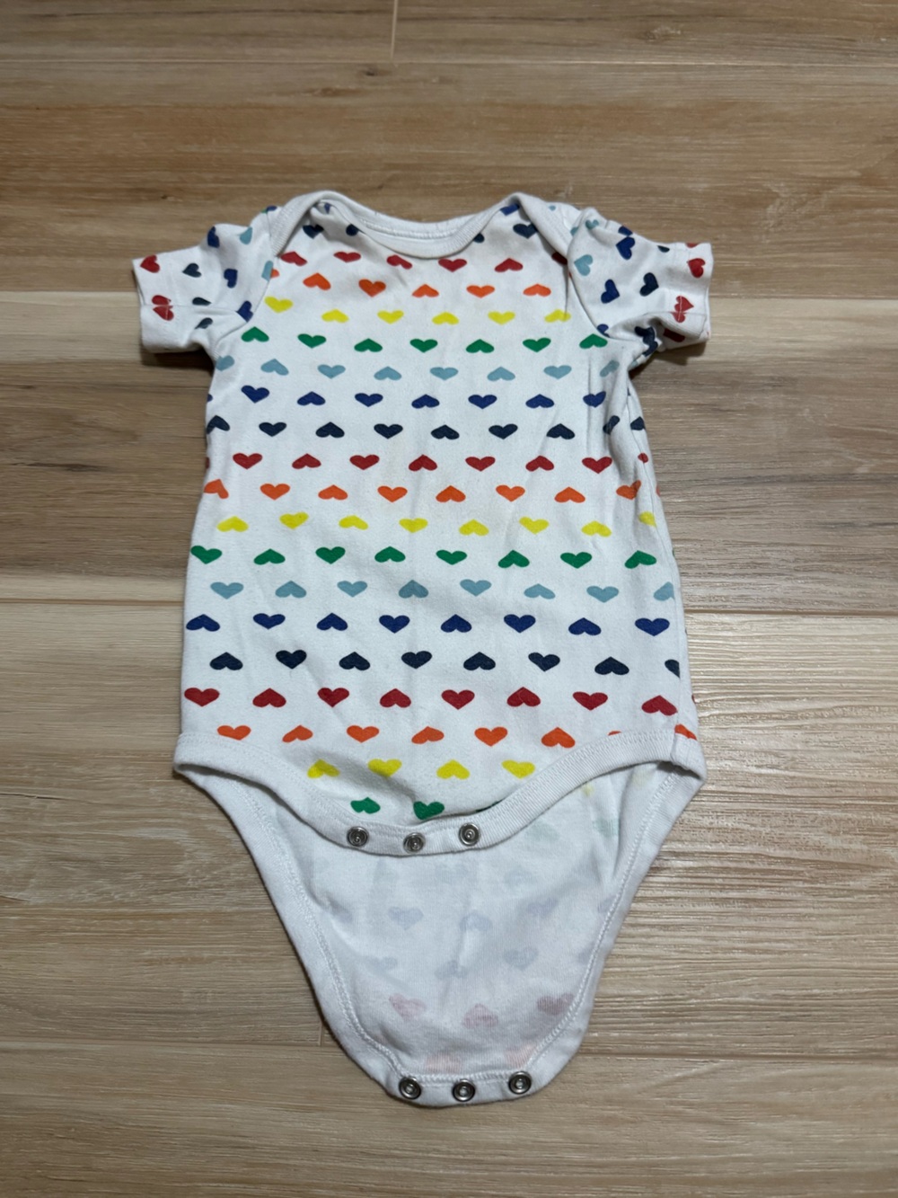 Primary rainbow hearts organic cotton onesie